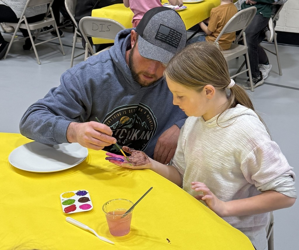 pictures of families enjoying a dinner plate painting craft at DIS' American Education Week Event