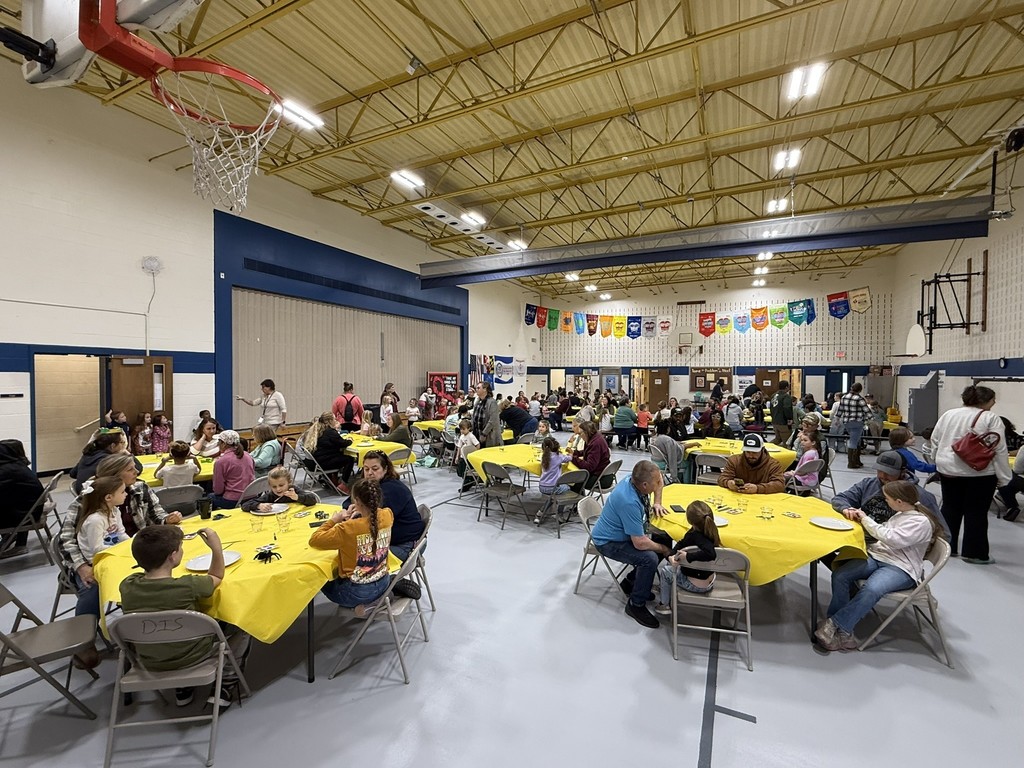 pictures of families enjoying a dinner plate painting craft at DIS' American Education Week Event