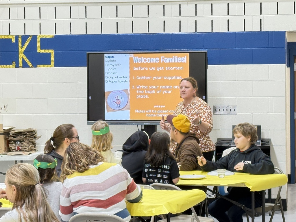 pictures of families enjoying a dinner plate painting craft at DIS' American Education Week Event