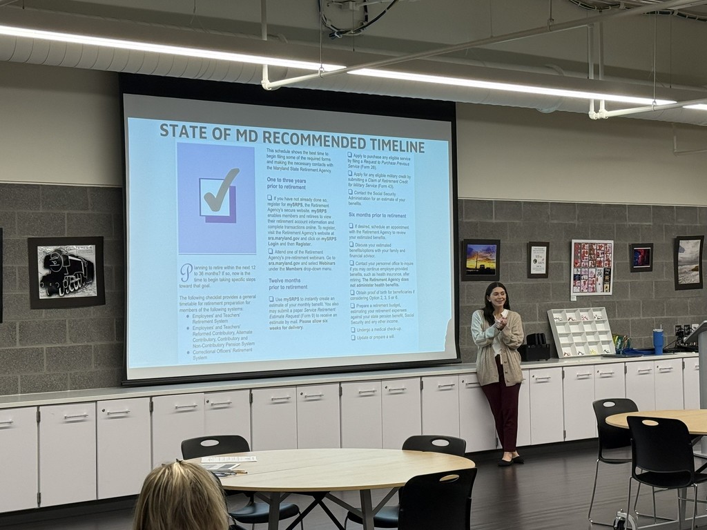 woman giving a presentation about retirement in a room with an audience