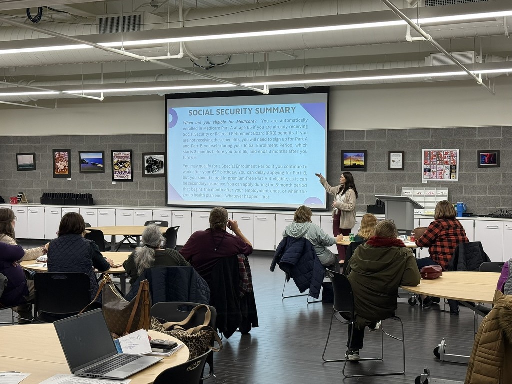 woman giving a presentation about retirement in a room with an audience