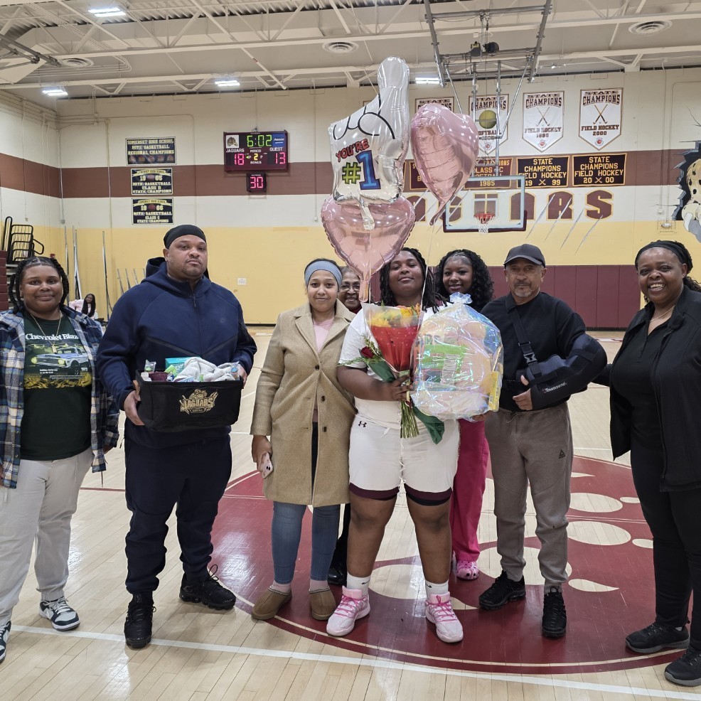 Anijah Jones with her family and coaches 