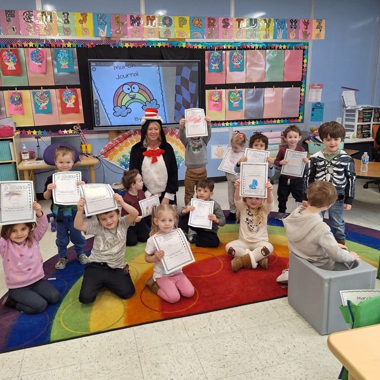 Teacher reading to students dressed as cat in the hat