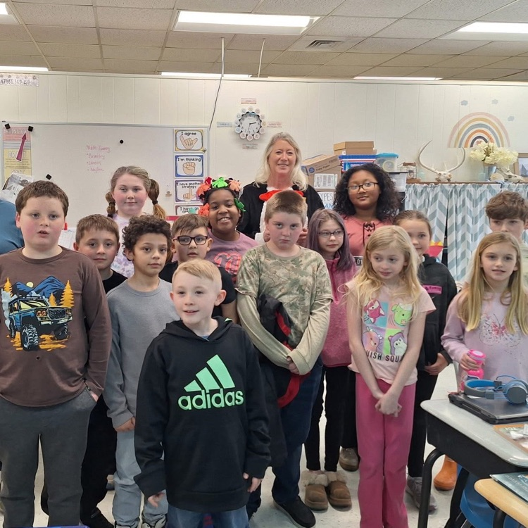 Teacher reading to students dressed as cat in the hat