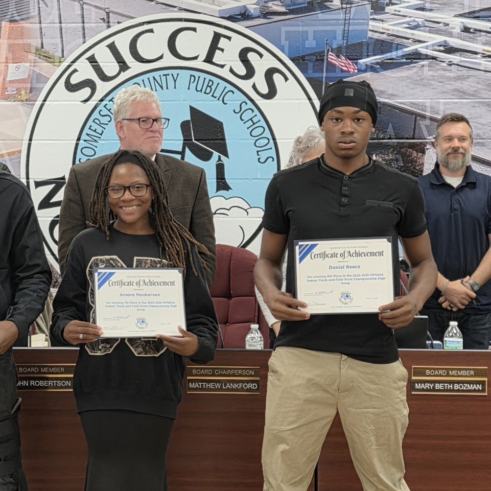 Amara and Daniel pictured with board of education members 