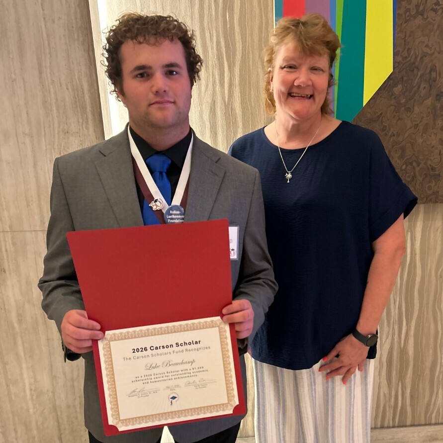 Luke with Ms Ferguson after receiving his award.