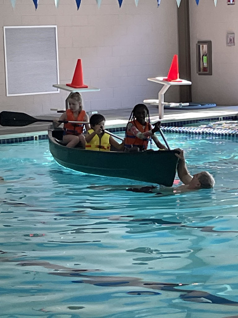 students rowing in a canoe