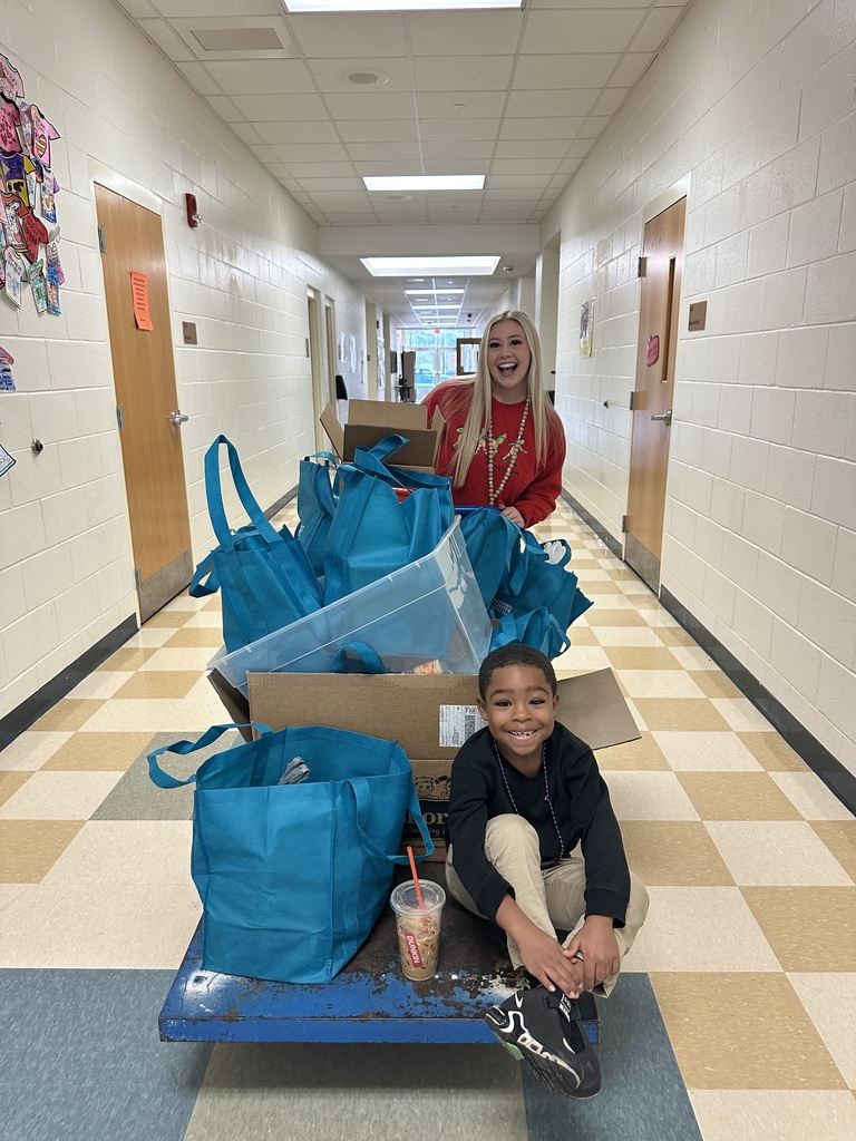 Staff and student with food drive donations