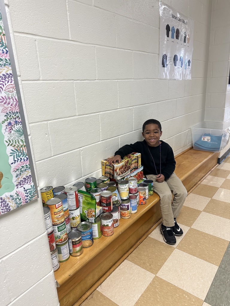 student with canned food donations