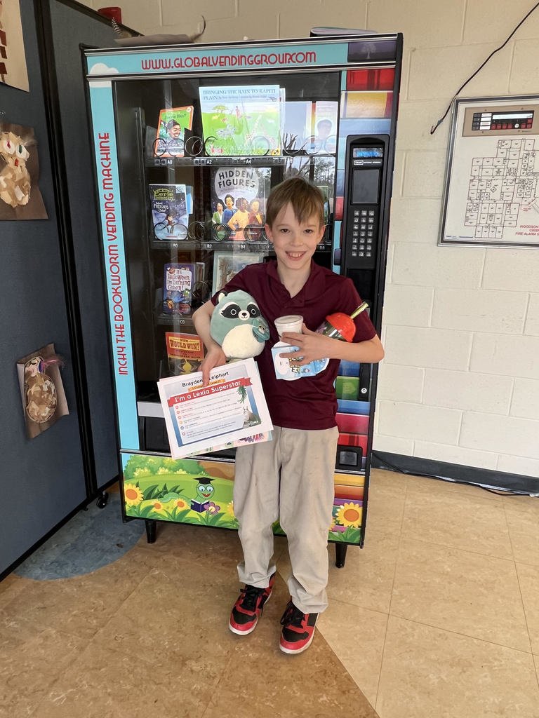 student standing in front of book machine