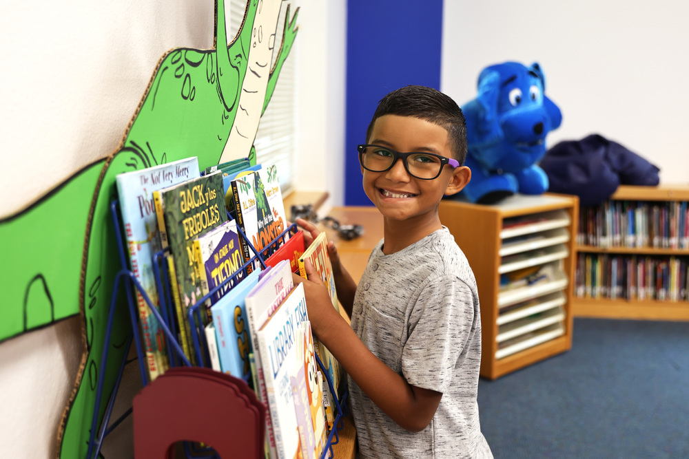 student grabbing a book