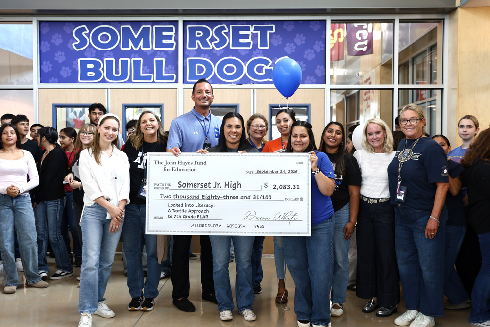 teachers holding a check