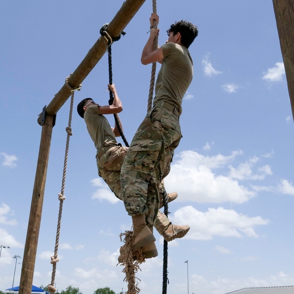 students jumping in obstacle course