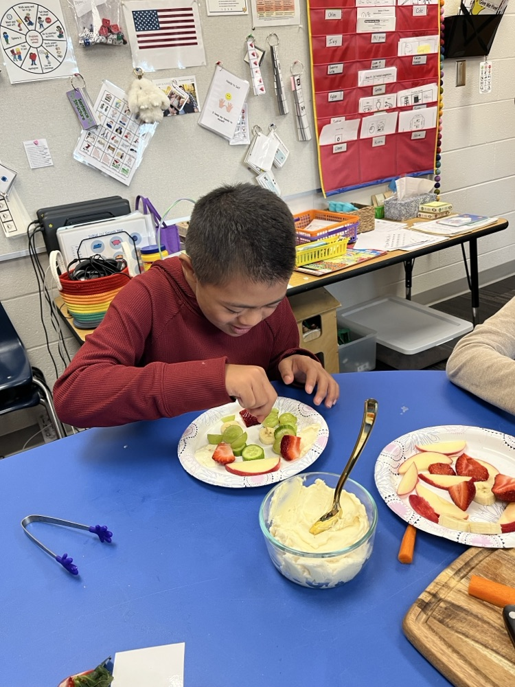 Students used cooking tools and explored different colors, smells, textures, and dip while building communication and fine motor skills.