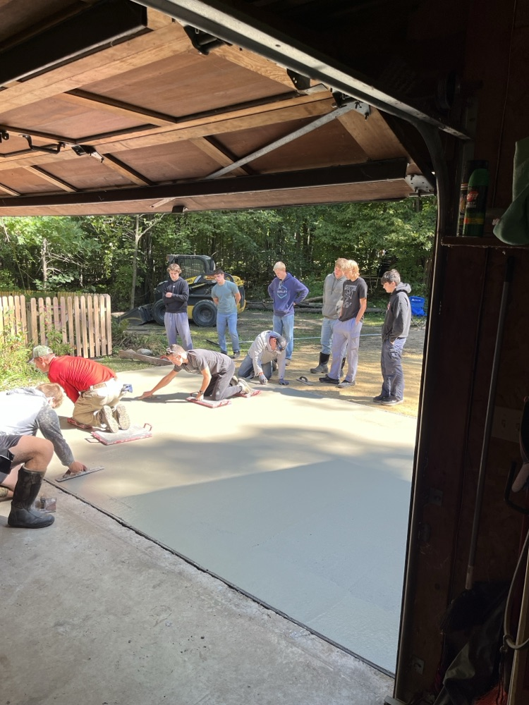 Students in Mr. Herink’s Building Construction Class gained valuable, hands-on, real-world experience yesterday as they poured a concrete apron for a community member.