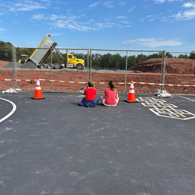 VDV students sit side by side watching construction