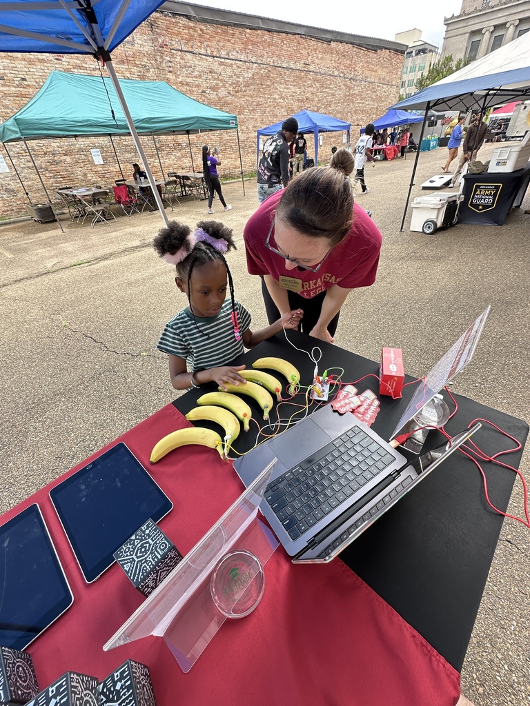 Child playing with Makey Makey banana piano