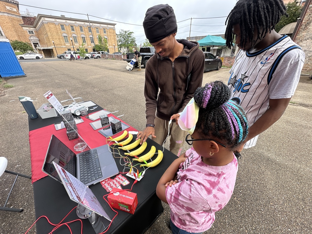 Visitors playing with Makey Makey banana piano