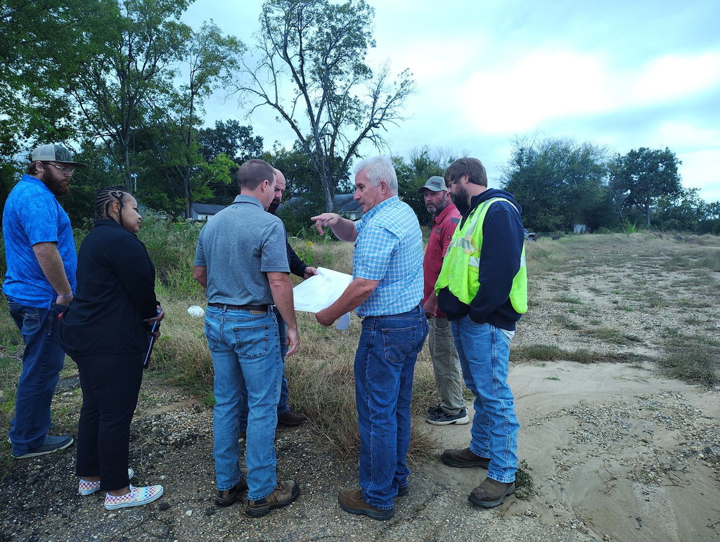 Image of architects and entergy discussing plans at Bill Howard Ballpark