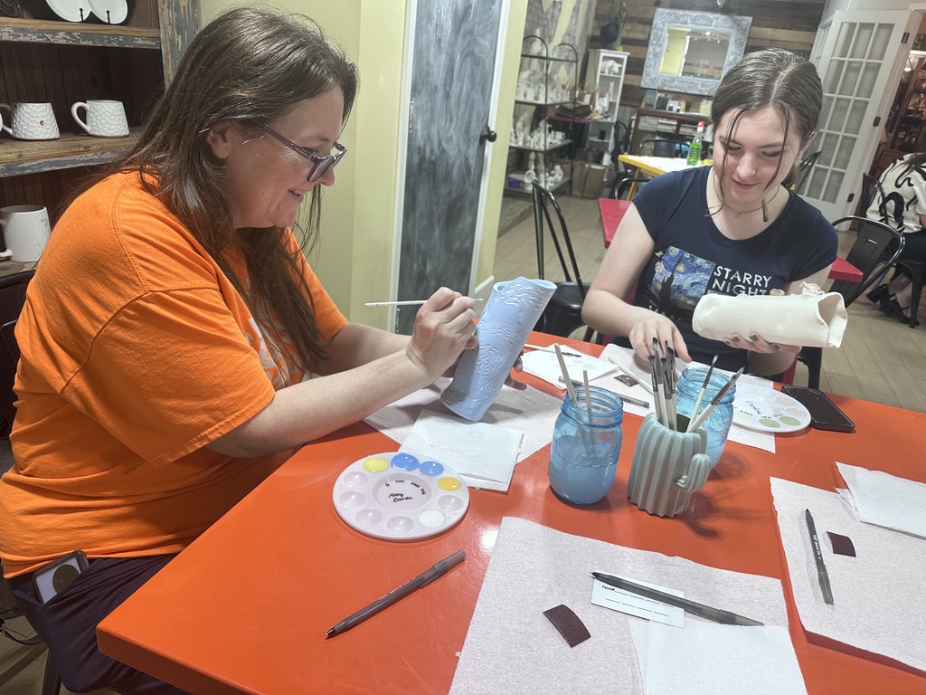 Community Members Decorating their clay vases for Arts in April