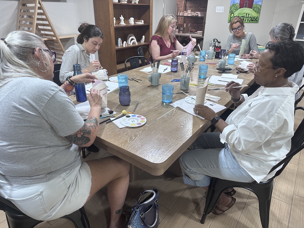 Community Members Decorating their clay vases for Arts in April