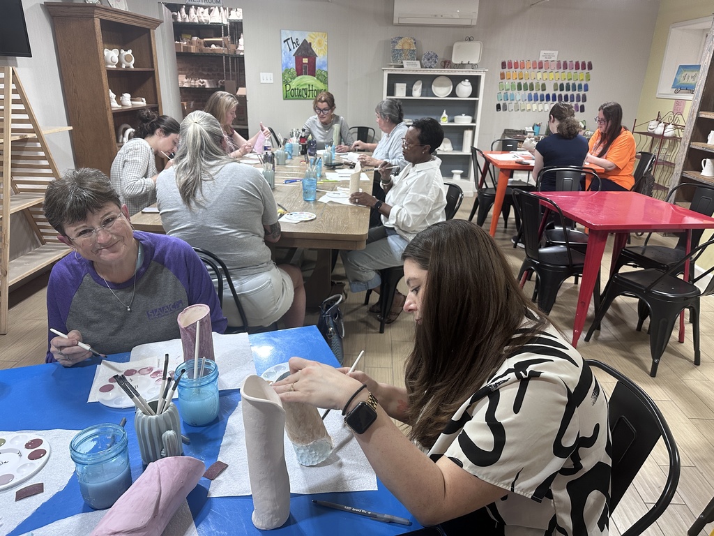 Community Members Decorating their clay vases for Arts in April