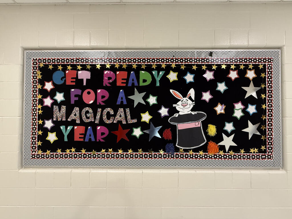 Black background with white stars. A magician's hat and rabbit. Text reads "Get ready for a magical year."
