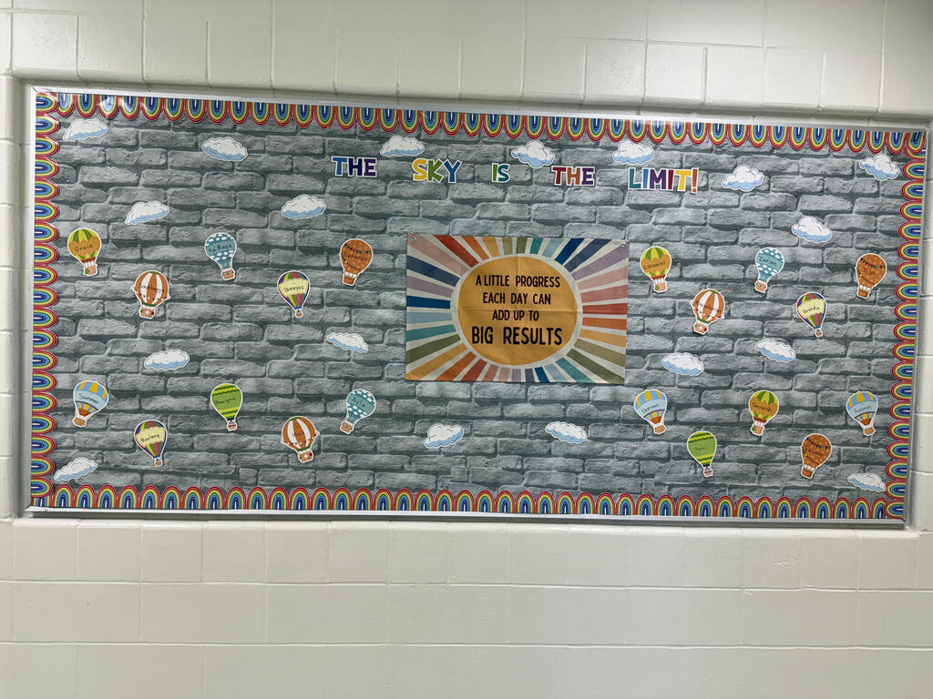 A wall displays a colorful mural with hot air balloons, clouds, and a rainbow border. A central circle contains the words "NO RESULTS."