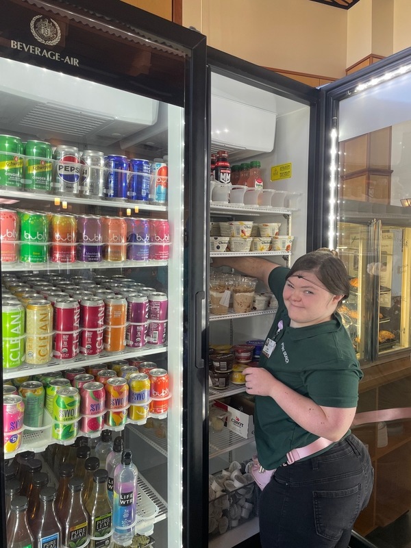 Project SEARCH worker stocking goods in the refridgerator
