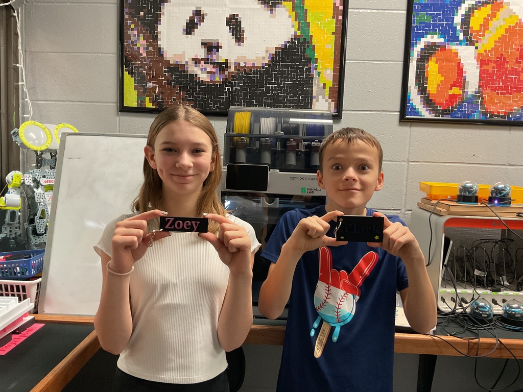 Students showing off their 3D printed keychains.