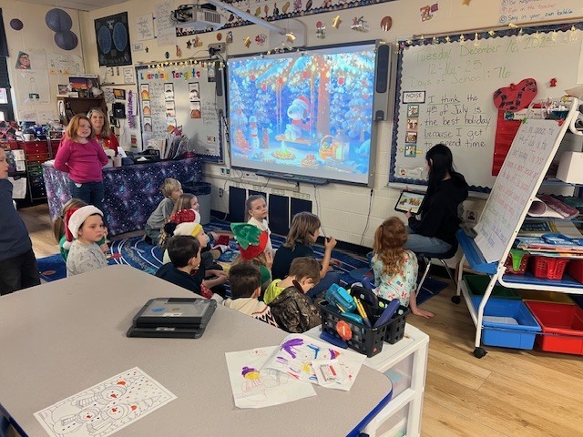 English IV students present children’s books they created to EC students.