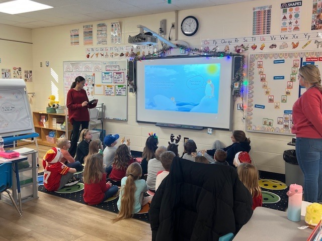 English IV students present children’s books they created to EC students.