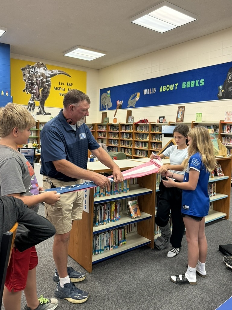 Mr. Hager helping fold US Flag