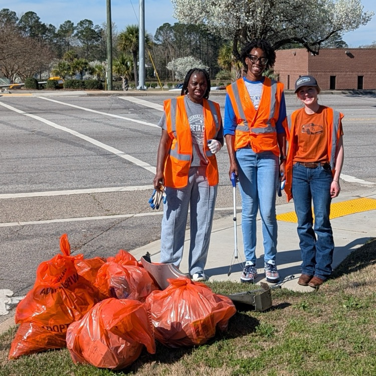student and faculty collecting trash