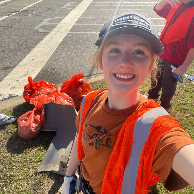 student and faculty collecting trash