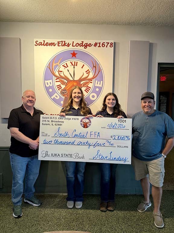 students holding check