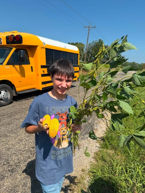 student holding corn