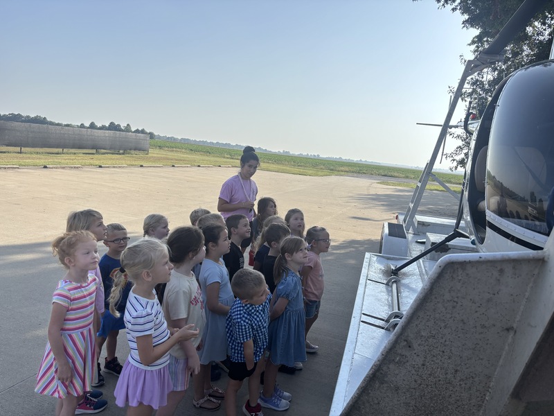 kids looking at helicopter