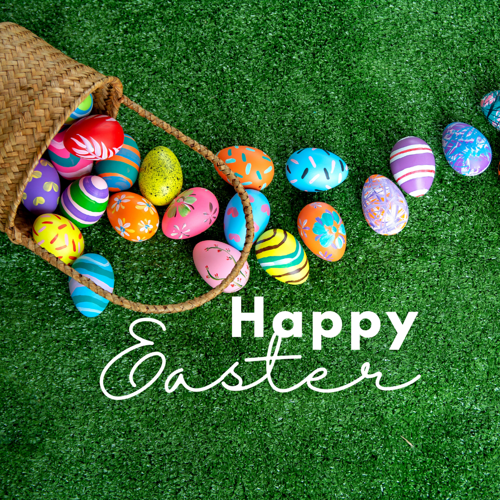 Happy Easter with a basket full of easter eggs on grass