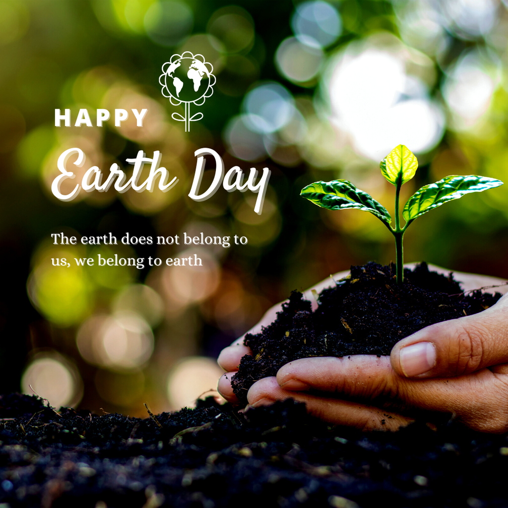 Happy Earth Day. The earth does not belong to us, we belong to earth. Hands in the soil holding a plant.