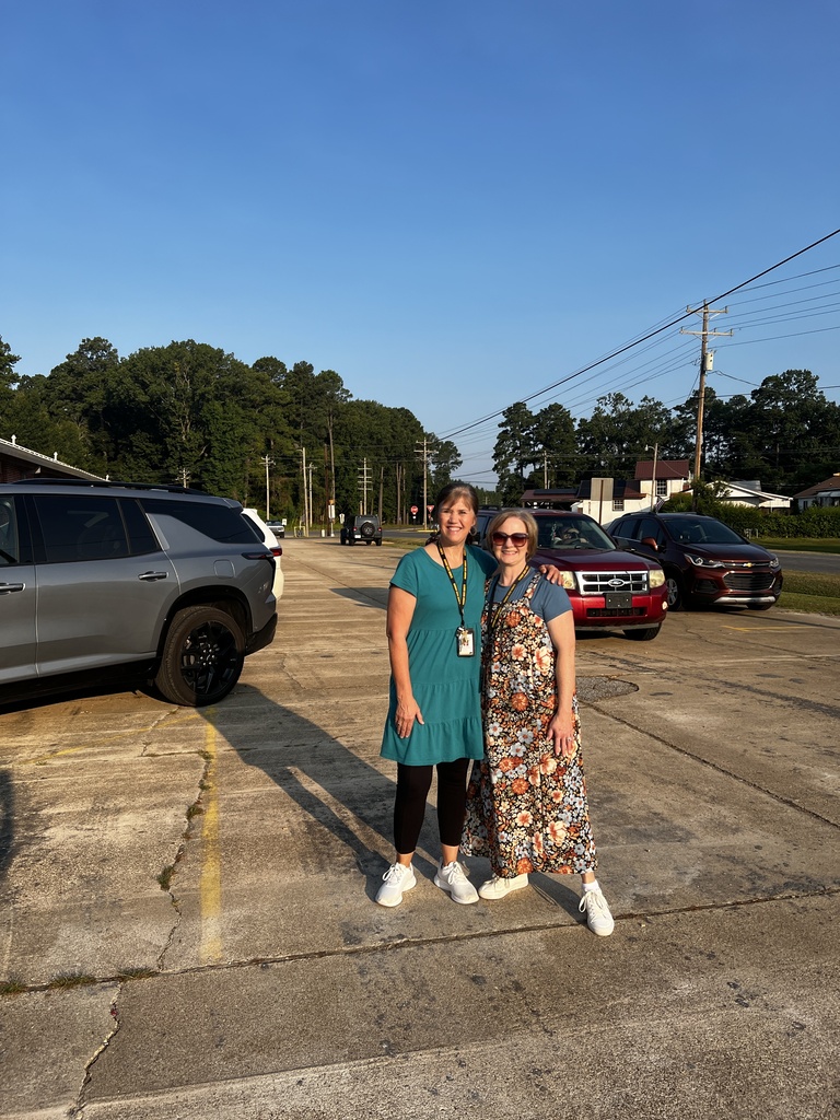 Teachers in the morning drop off line greeting students. 