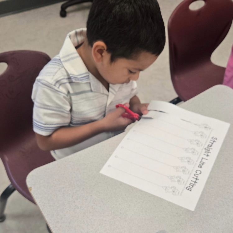 Student working on using scissors