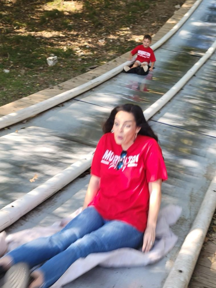 teacher and child on slide