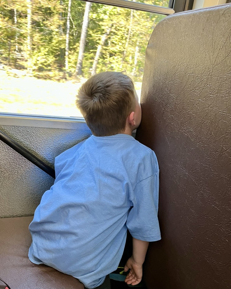 child asleep on bus