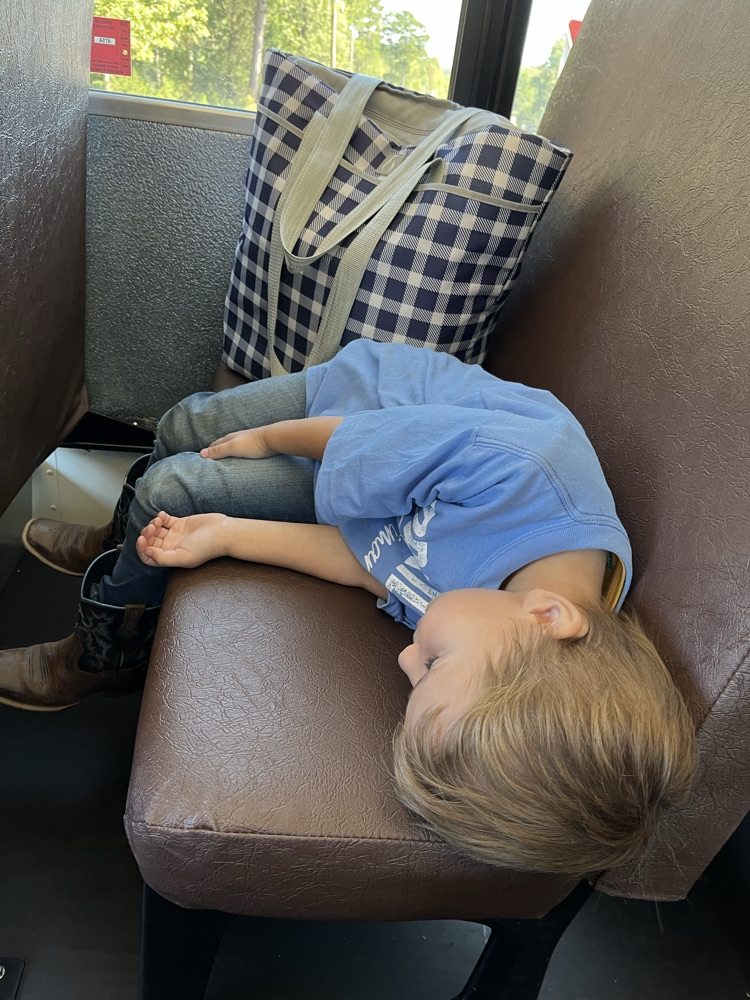 child asleep on bus