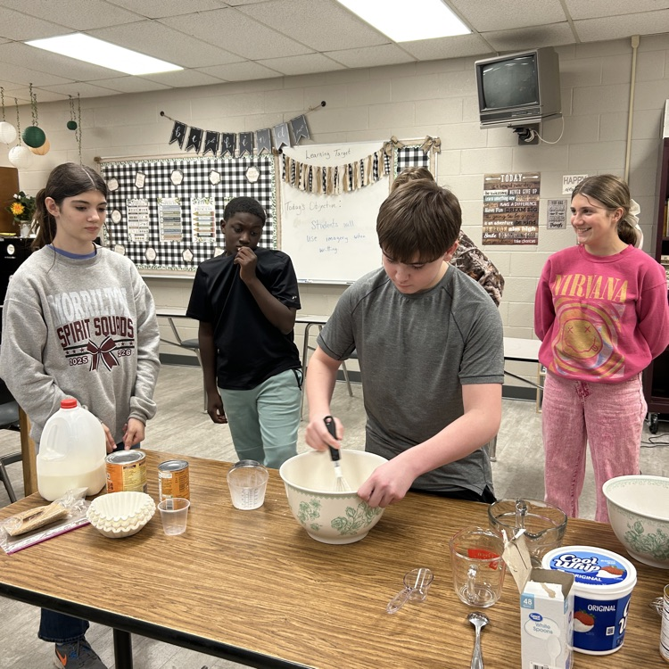 student stirring while others watch