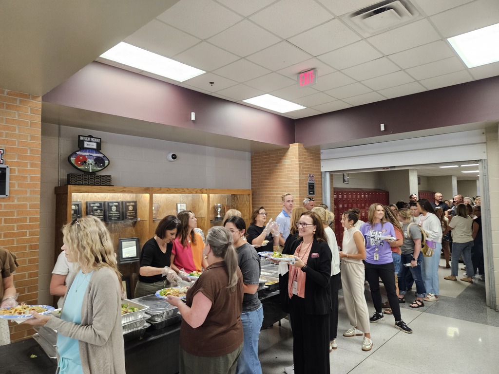 Community members serving meals to faculty/staff.