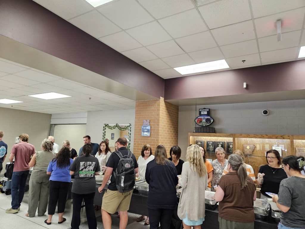 Community members serving meals to faculty/staff.