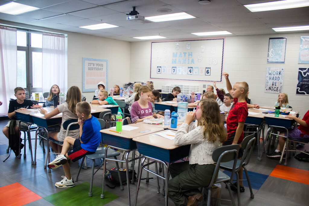 Fourth-grade AES students guess answers to Ms. Rayner's personal trivia questions to learn more about their new teacher.