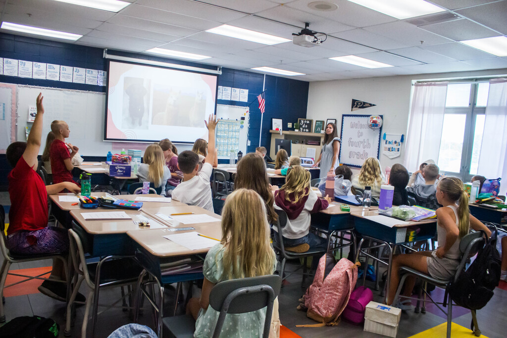 Fourth-grade AES students guess answers to Ms. Rayner's personal trivia questions to learn more about their new teacher.